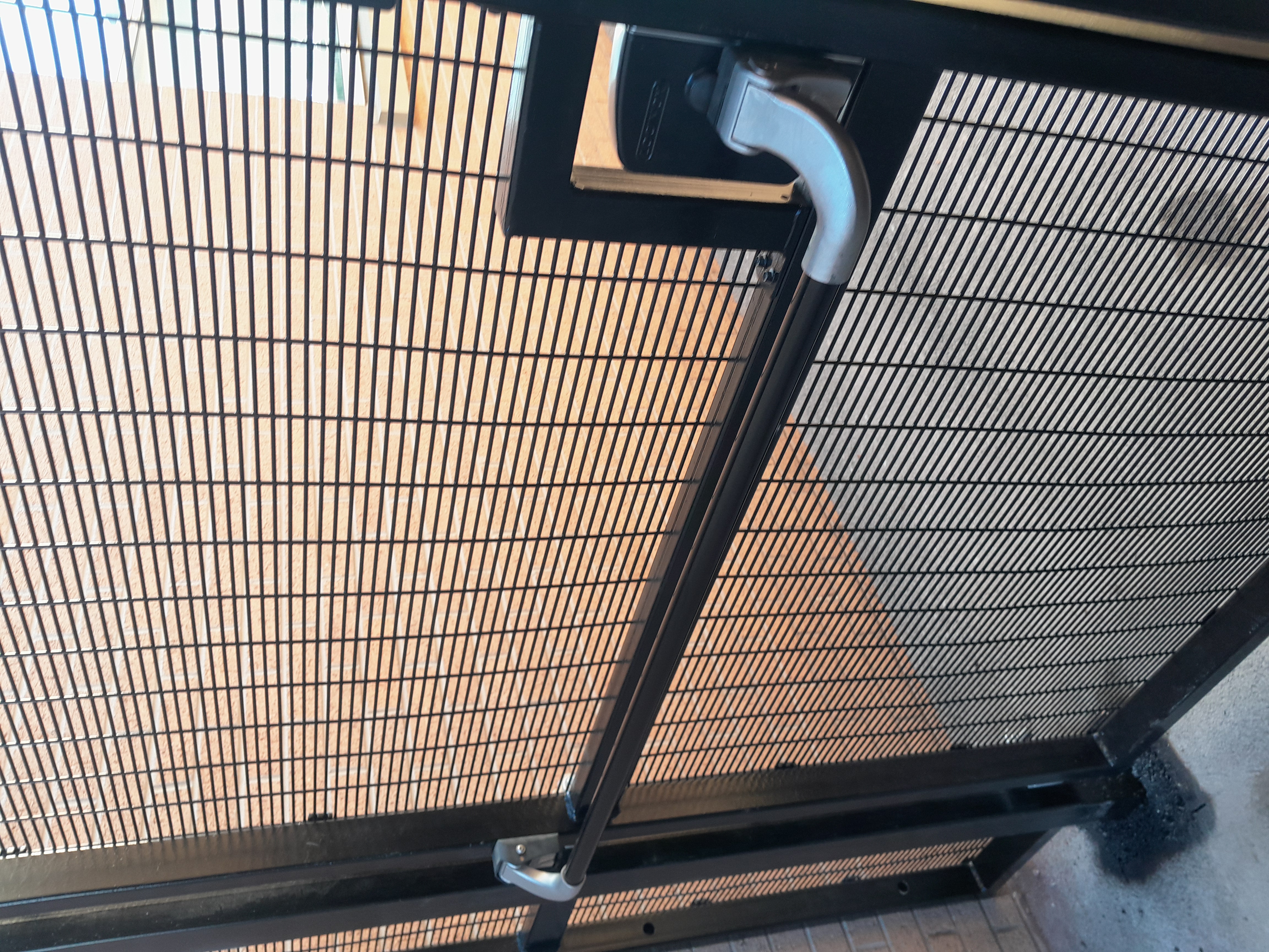 Off-grid access gate in narrow service corridor